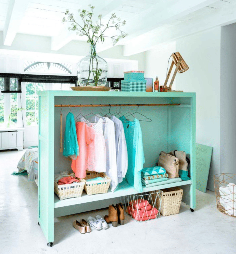 WHAT IS A TINY HOUSE? THE AFFORDABLE HOUSING OPTION EXPLAINED IN 2024 29 clothing rack room divider