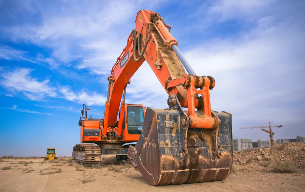 COST TO BUILD AN ADU, COSTLY MISTAKES TO AVOID & MONEY SAVING TIPS 8 Low Angle Photography of Orange Excavator Under White Clouds