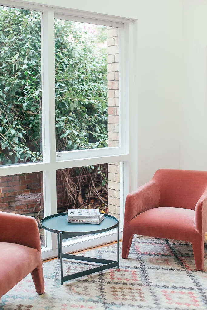 39 VALUABLE ADU IDEAS TO OPTIMIZE SPACE IN A BACKYARD BUILD (700+ PICS) 123 Comfortable armchairs with small round table placed near window in cozy living room of spacious villa