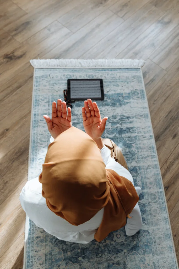 HOW TO DOWNSIZE INTO A TINY HOUSE - THE EASY WAY 3 High-Angle Shot of a Person Kneeling on a Blue Prayer Rug