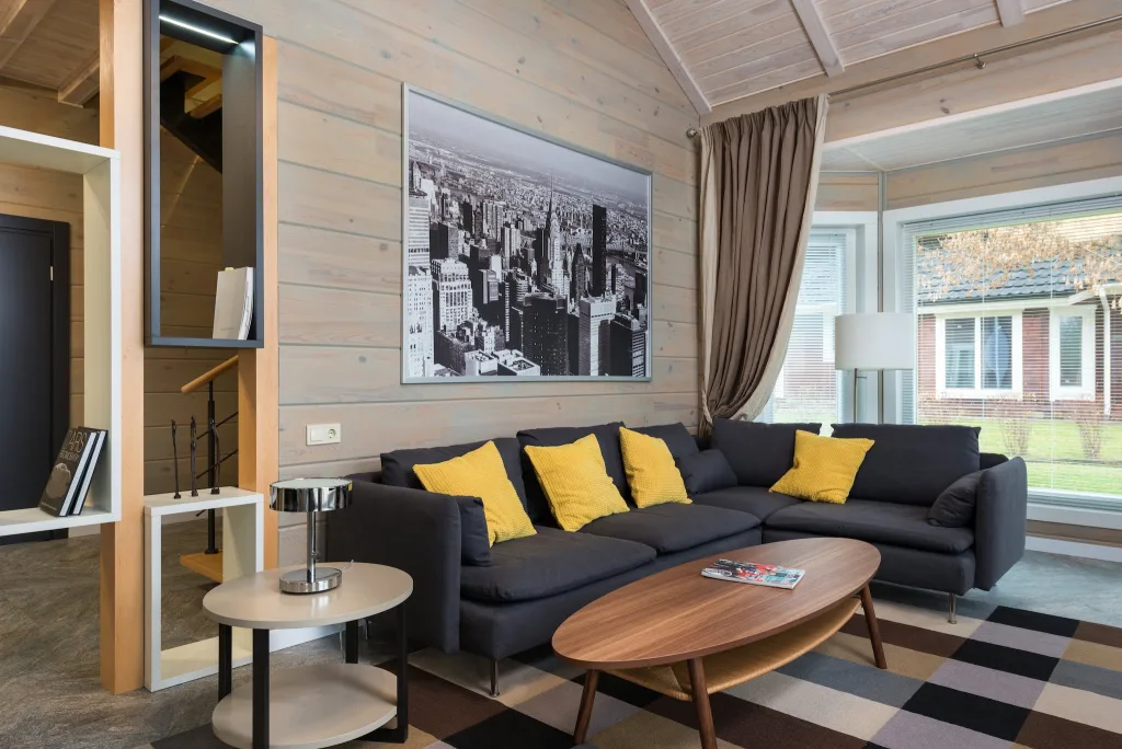 39 VALUABLE ADU IDEAS TO OPTIMIZE SPACE IN A BACKYARD BUILD (700+ PICS) 153 Interior design of contemporary villa with decorative picture hanging above couch placed near round table and geometric shelves