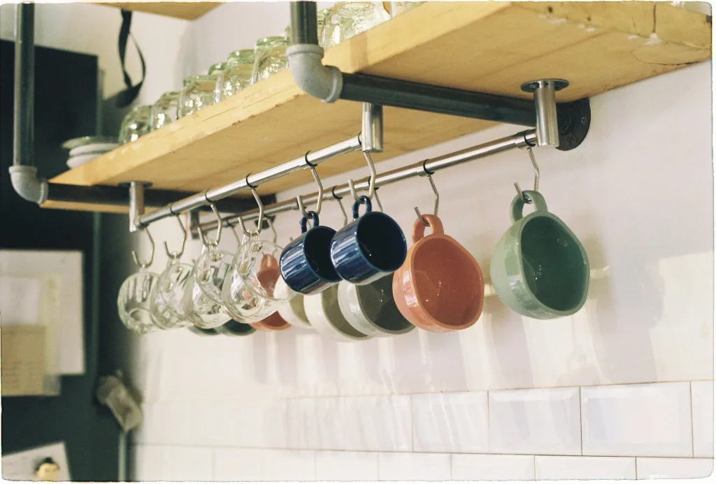 ADU VS TINY HOUSE: 12 KEY DIFFERENCES EXPLAINED 21 Mugs Hanging on Shelf on Home Kitchen
