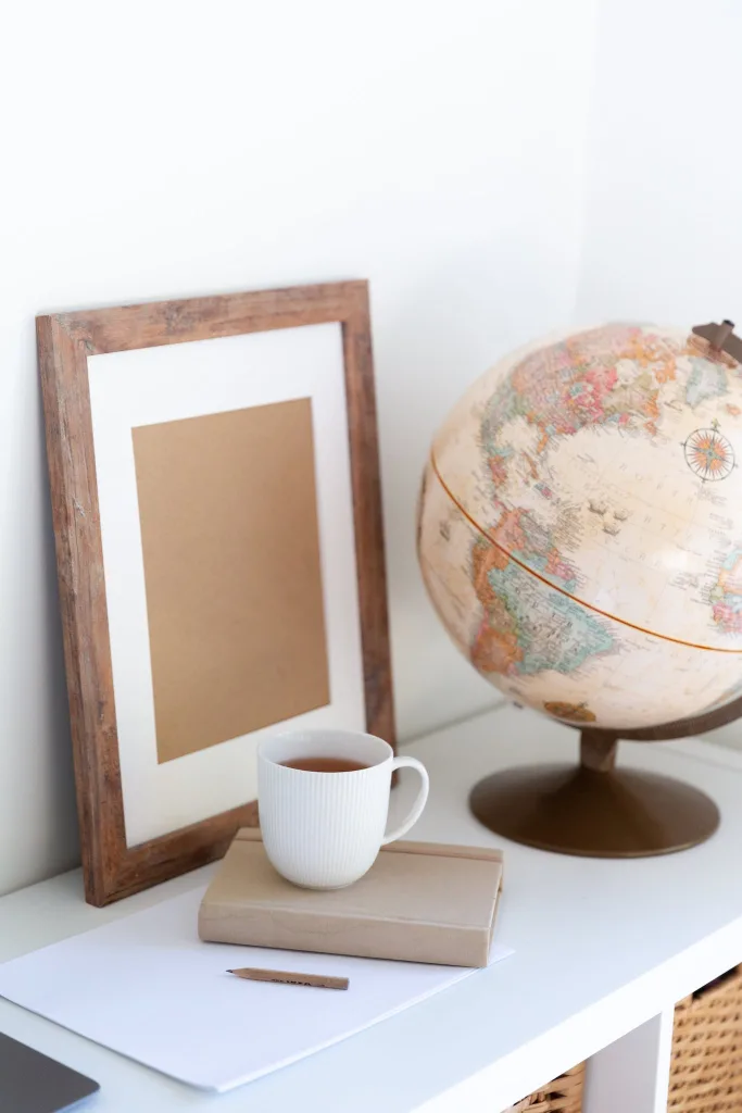 39 VALUABLE ADU IDEAS TO OPTIMIZE SPACE IN A BACKYARD BUILD (700+ PICS) 143 Vintage globe near blank frame and cup of tea placed on book in office