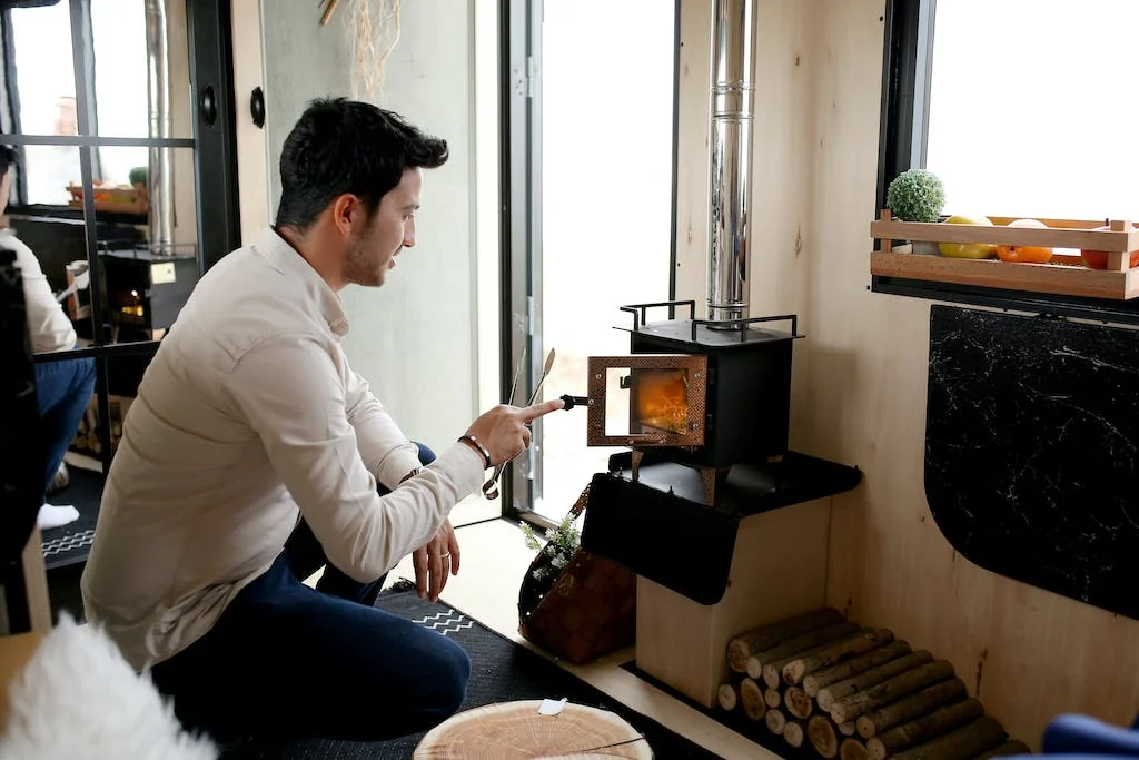 man in front of a wood stove