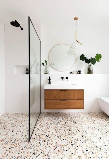 19 SMALL BATHROOM FLOOR TILE IDEAS: ADDING PERSONALITY TO A TINY HOUSE 10 Minimalist terrazzo floors in subdued tones lend a contemporary chic to this small wash space, coupled with a sleek wooden vanity and a clean-lined glass shower separator.