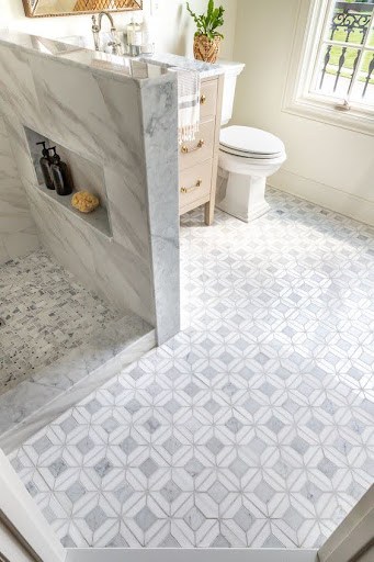 19 SMALL BATHROOM FLOOR TILE IDEAS: ADDING PERSONALITY TO A TINY HOUSE 11 Opulent Marble Mosaic Tiles grace this compact ensuite, harmonized with a pristine marble shower, exuding a spacious and refined atmosphere.