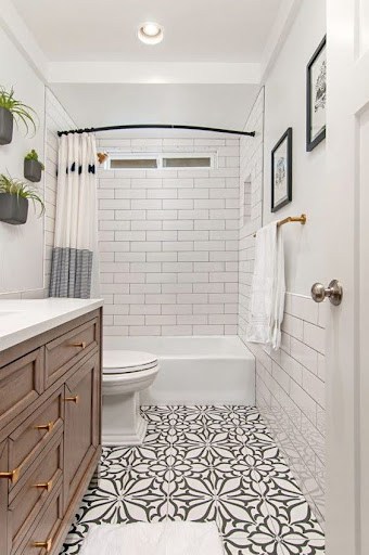 19 SMALL BATHROOM FLOOR TILE IDEAS: ADDING PERSONALITY TO A TINY HOUSE 12 In this snug wash area, elaborate white and grey floral motifs on the Patterned Cement Tiles create a sophisticated aura, complemented by minimalist subway tiles and wooden cabinetry.