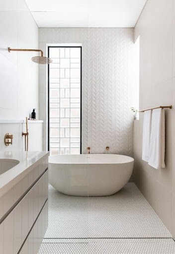 18 SMALL BATHROOM WINDOW IDEAS FOR NATURAL LIGHT AND PRIVACY 11 Contemporary bathroom boasting a free-standing oval bathtub, geometric patterned wall, and a narrow floor-to-ceiling Glass Blocks window for light and solitude.