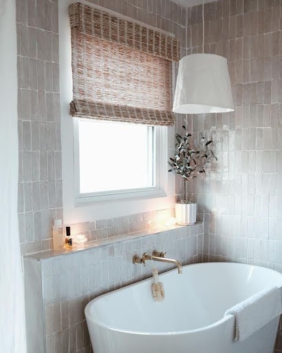 18 SMALL BATHROOM WINDOW IDEAS FOR NATURAL LIGHT AND PRIVACY 14 Contemporary bathroom boasting a free-standing oval bathtub, with roman shade window and a chandelier made of paper and a plant base