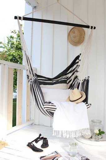 20 SMALL PATIO FURNITURE IDEAS TO MAKE A BIG IMPACT 6 Petite porch hammock chair creating a stylish, tranquil corner for relaxation.