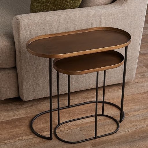 20 SMALL PATIO FURNITURE IDEAS TO MAKE A BIG IMPACT 11 Sleek and slim nesting side tables featuring oval tops, designed to conserve space in a small room while offering ample utility.