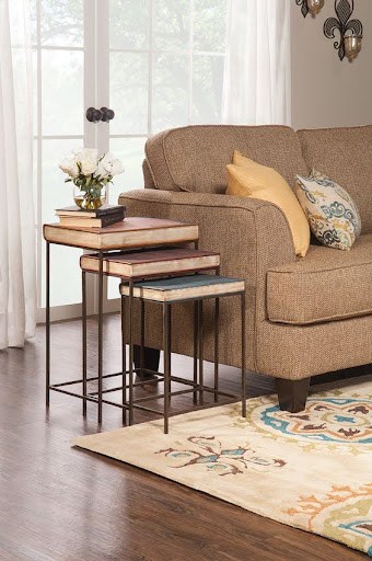 20 SMALL PATIO FURNITURE IDEAS TO MAKE A BIG IMPACT 12 A trio of space-efficient wooden nesting tables beside a cozy sofa, demonstrating a versatile solution for tight living quarters.