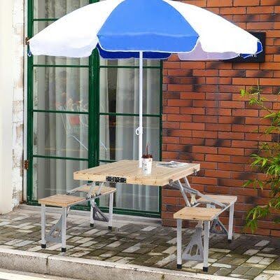 20 SMALL PATIO FURNITURE IDEAS TO MAKE A BIG IMPACT 17 A compact outdoor dining set with a wooden table, benches, and a blue umbrella, offering a simple and efficient solution for small patio spaces.