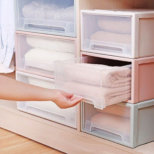 22 AWESOME SMALL WALK-IN CLOSET IDEAS FOR TINY HOMES & ADUS 18 See-through drawers/ Transparent Boxes neatly storing linens, showcasing a tidy and accessible linen closet.