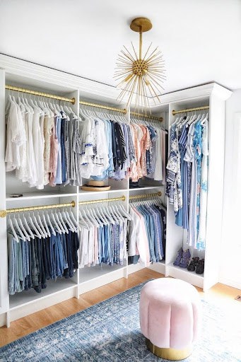 22 AWESOME SMALL WALK-IN CLOSET IDEAS FOR TINY HOMES & ADUS 23 A chic Free Standing Closet featuring gold accents, pastel seating, and organized racks for a soft, fashionable touch.