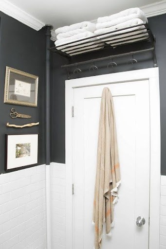 TOWEL STORAGE FOR A SMALL BATHROOM: 19 CREATIVE SOLUTIONS 3 White towels stacked over a bathroom door, a smart space-saver for small bathrooms.