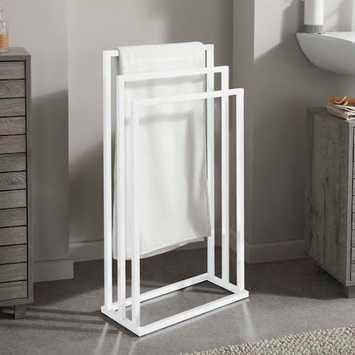 TOWEL STORAGE FOR A SMALL BATHROOM: 19 CREATIVE SOLUTIONS 7 A white freestanding towel rack, a smart and stylish way to organize towels in a limited bathroom space.