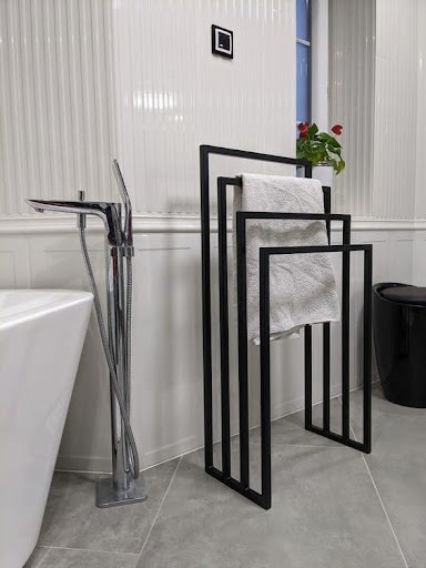 TOWEL STORAGE FOR A SMALL BATHROOM: 19 CREATIVE SOLUTIONS 8 A minimalist towel holder with multiple bars, offering a sleek and modern towel hanging solution for a small bathroom.