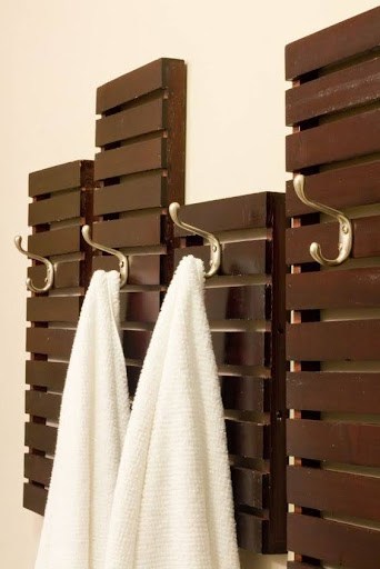 TOWEL STORAGE FOR A SMALL BATHROOM: 19 CREATIVE SOLUTIONS 15 Wooden slats with hooks holding white towels, adding a rustic touch to towel storage in a small bathroom