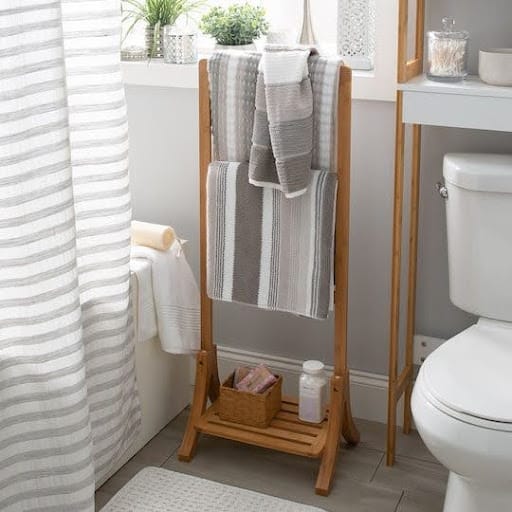 TOWEL STORAGE FOR A SMALL BATHROOM: 19 CREATIVE SOLUTIONS 19 Freestanding Towel Rack against a white wall, a simple and efficient way to hang towels in a small bathroom.