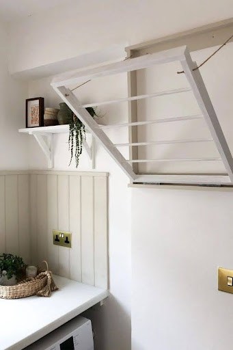 TOWEL STORAGE FOR A SMALL BATHROOM: 19 CREATIVE SOLUTIONS 25 White Fold-Down Wall Rack with hanging space below, an elegant solution for towel storage in small bathrooms.