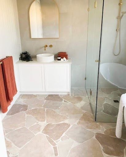 19 SMALL BATHROOM FLOOR TILE IDEAS: ADDING PERSONALITY TO A TINY HOUSE 17 A small en suite bathroom with uniquely shaped soft pink Stone-Look Porcelain Tiles and a clear glass shower partition exudes simplicity and modernity.