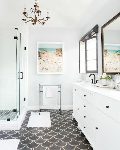 19 SMALL BATHROOM FLOOR TILE IDEAS: ADDING PERSONALITY TO A TINY HOUSE 19 The chic lavatory pairs a striking Moroccan Black Fish Scale Pattern with a crisp white shower, creating a modern, nautical-inspired look in a compact setting.