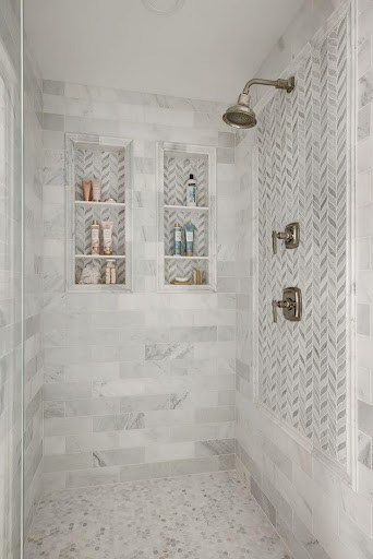 21 SMALL BATHROOM SHOWER IDEAS PERFECT FOR TINY HOUSES & ADUS 5 Compact small bathroom Shower Niche or Built-In Shelves with intricate herringbone patterned tile work and built-in shelves in a small bathroom.