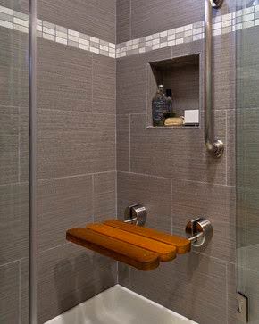 21 SMALL BATHROOM SHOWER IDEAS PERFECT FOR TINY HOUSES & ADUS 7 Tiny shower space with Folding or Telescoping Bench textured grey tiles, a recessed shelf, and a wooden corner seat, exemplifying efficient use of space.
