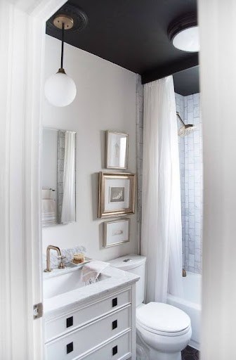 21 SMALL BATHROOM SHOWER IDEAS PERFECT FOR TINY HOUSES & ADUS 18 Charming and efficient small bathroom layout with a Tubular Skylight classic white scheme, a framed shower curtain, and smart mirror placement for a spacious ambiance.