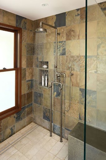 21 SMALL BATHROOM SHOWER IDEAS PERFECT FOR TINY HOUSES & ADUS 23 Rustic little bathroom shower with Expose Plumbing Pipes, slate and sandstone tiles, featuring modern fixtures and a clear glass door for an earthy yet contemporary look.