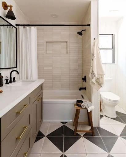 19 SMALL BATHROOM FLOOR TILE IDEAS: ADDING PERSONALITY TO A TINY HOUSE 7 A modern small bathroom with bold geometric black and white Checkerboard Pattern tiles, and matte black fixtures creating a chic contrast.