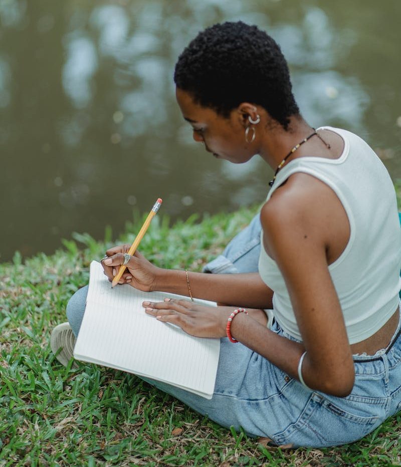 DIFFERENCES BETWEEN A TOWNHOUSE AND A CONDO: SIMPLIFIED & EXPLAINED 7 African American woman writing in diary on meadow