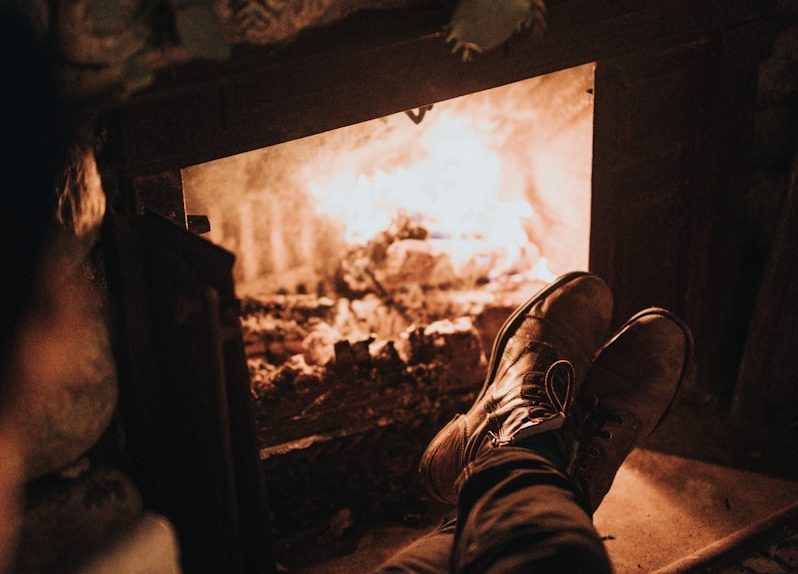 TINY HOUSE FIREPLACES FOR SMALL SPACES: COMPACT COMFORT 2 man sitting in front of the fireplace